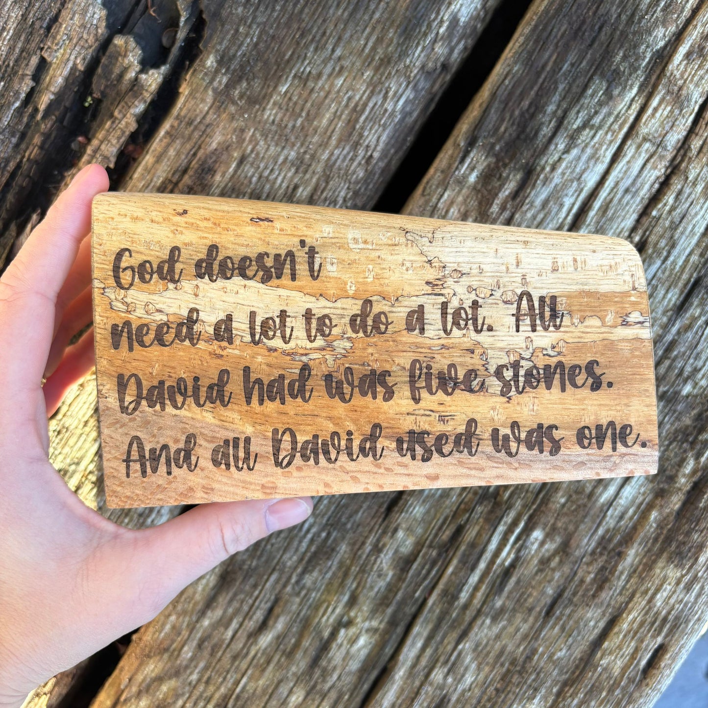 'God doesn't need a lot' solid wood plaque