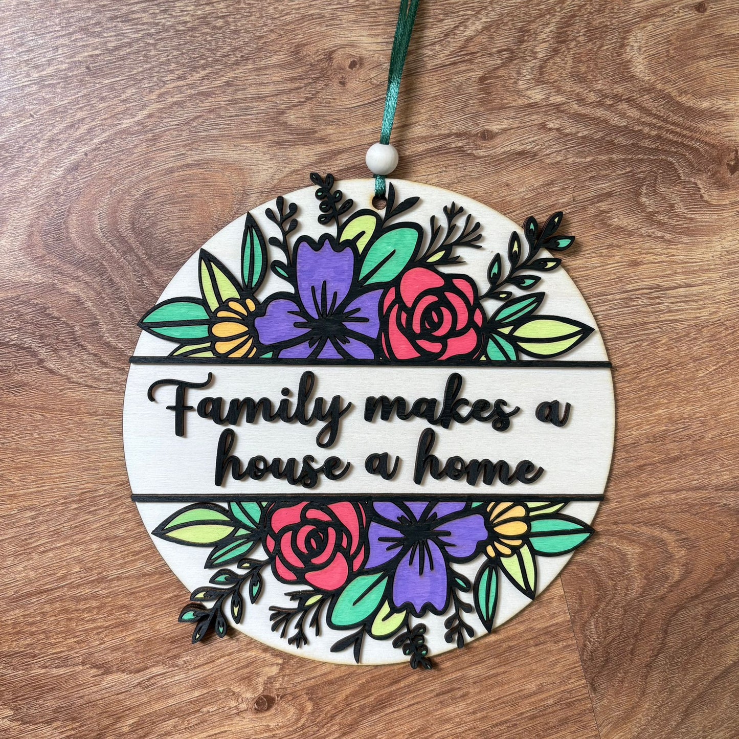 ‘Family makes a house a home' - wooden hanging plaque